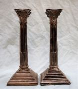 A pair of Elizabeth II silver Corinthian column candlesticks,