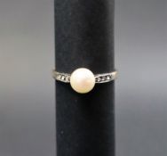 A pearl set ring to a white metal setting and yellow metal shank, marked 9ct & Sil,