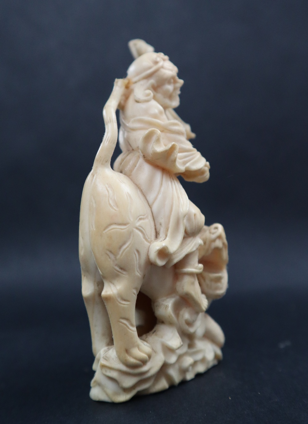 A simulated ivory figure group of a figure riding a tiger, 11cm high, - Image 4 of 7
