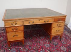 A late 19th century mahogany partners desk with a leather inset top above three drawers to either