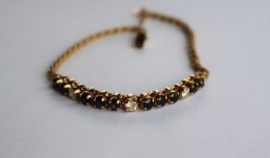 An 18ct yellow gold diamond and sapphire bracelet set with ten sapphires and three diamonds to a