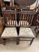 A set of four oak dining chairs with barley twist uprights and legs