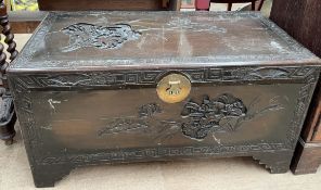 A carved and stained Chinese camphor wood coffer