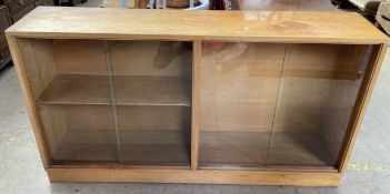 A 20th century oak display cabinet with a pair of sliding glass doors