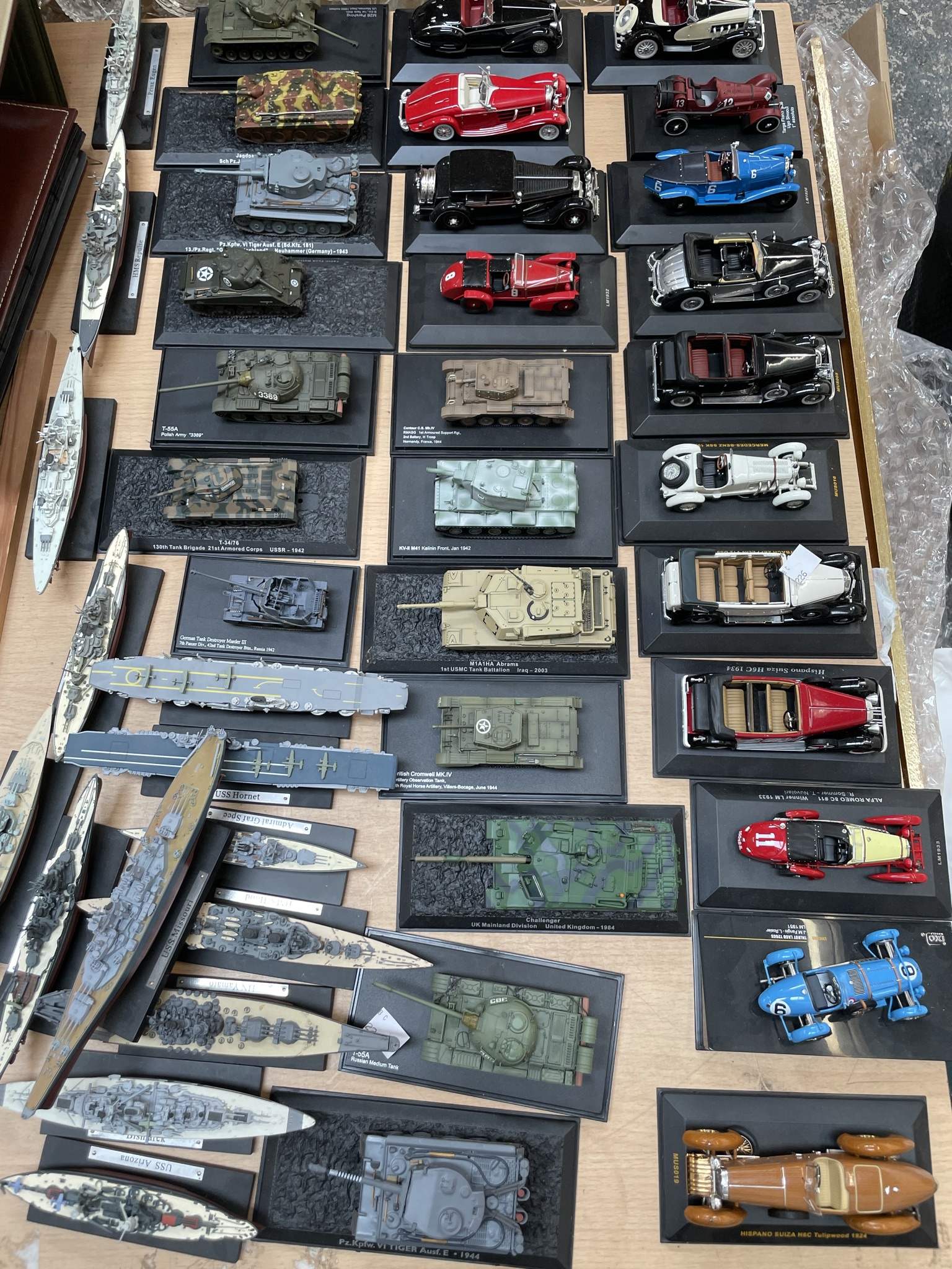 An assortment of modern collectors car together with model ships etc