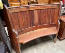 An arched pine pew