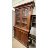 A Victorian mahogany bookcase, with a moulded cornice above a pair of glazed doors,