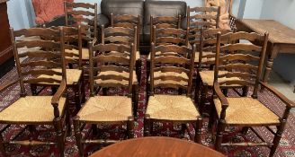 A set of twelve ladderback dining chairs, with rush seats on turned legs,