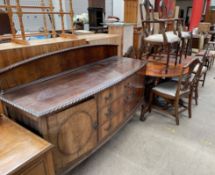 A 20th century mahogany sideboard together with a reproduction mahogany extending dining table and