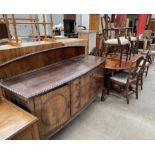 A 20th century mahogany sideboard together with a reproduction mahogany extending dining table and