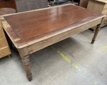 A Victorian walnut library table with an inset top on turned legs