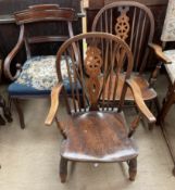 A pair of wheel back elbow chairs together with a Regency mahogany elbow chair