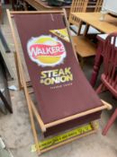 A deck chair with advertising for Walkers Steak and Onion flavour crisps