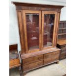 A 19th century mahogany bookcase, with a moulded cornice above a pair of glazed doors,