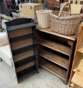 A stained pine bookcase together with a stained oak bookcase a wicker waste paper bin and a wicker