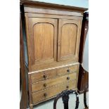 A Victorian oak linen press, the moulded cornice above a pair of cupboard doors enclosing shelves,