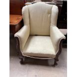 An early 20th century wing back library chair,