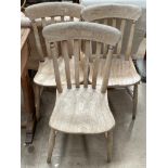 A set of three slat back kitchen dining chairs