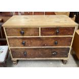 A Victorian pine chest with a rectangular top above two short and two long drawers on turned feet