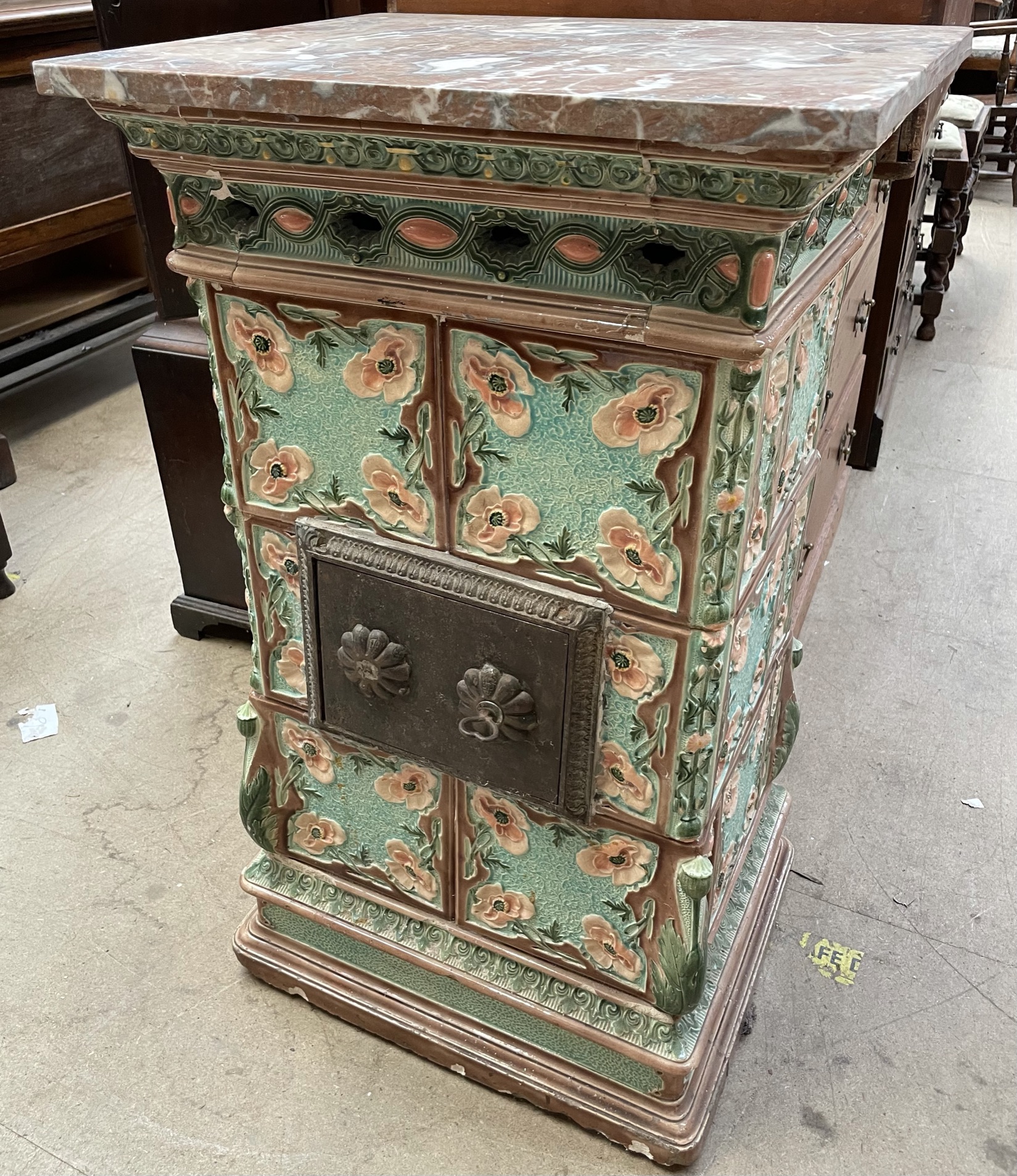 An Art Nouveau pottery stove, with a marble top,