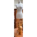 A dress makers dummy, on a stand,