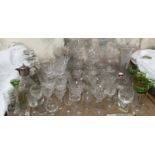 A large collection of crystal drinking glasses, decanters,