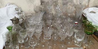 A large collection of crystal drinking glasses, decanters,