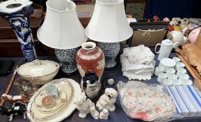 Two Beswick cavalier King Charles Spaniels together with a pair of blue and white table lamps,