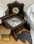 A black slate mantle clock together with a wall clock and a brass carriage clock