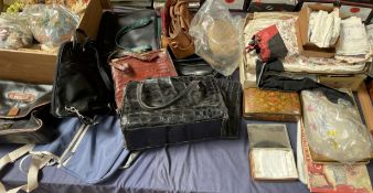 A collection of handbags, linens,