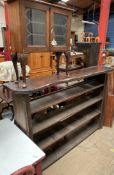 A rustic bookcase with four shelves together with a display cabinet on cabriole legs