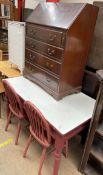 A painted pine kitchen table together with a pair of spindle back dining chairs and a reproduction