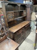 A 20th century oak dresser, the rack with carved door and shelves,