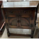 A 20th century oak side cabinet with a frieze drawer and a pair of oak doors