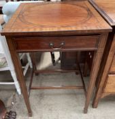 An early 20th century mahogany side table the square top above a frieze drawer on square tapering