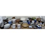 A Cornishware storage jar together with assorted plates,