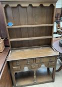 A 20th century oak dresser, with a moulded cornice above two shelves,