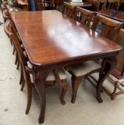 A reproduction mahogany extending dining table of rectangular form with cabriole legs together with