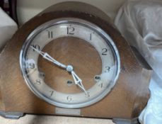 An oak cased mantle clock, with a silvered dial,