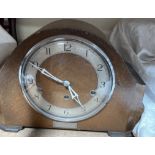 An oak cased mantle clock, with a silvered dial,