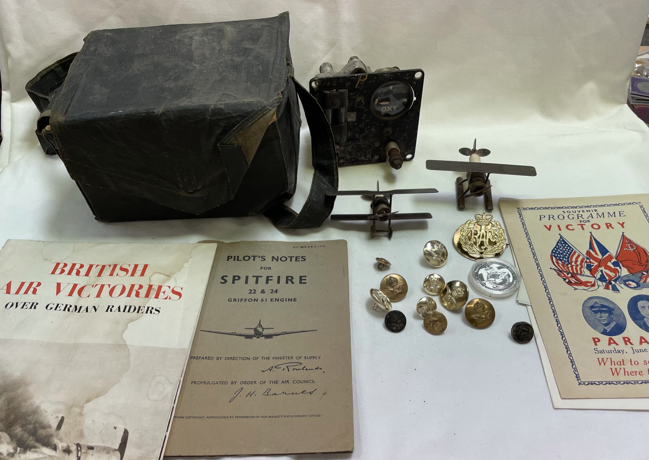 An oxygen regulator, probably from a spitfire together with model planes made from spark plugs,