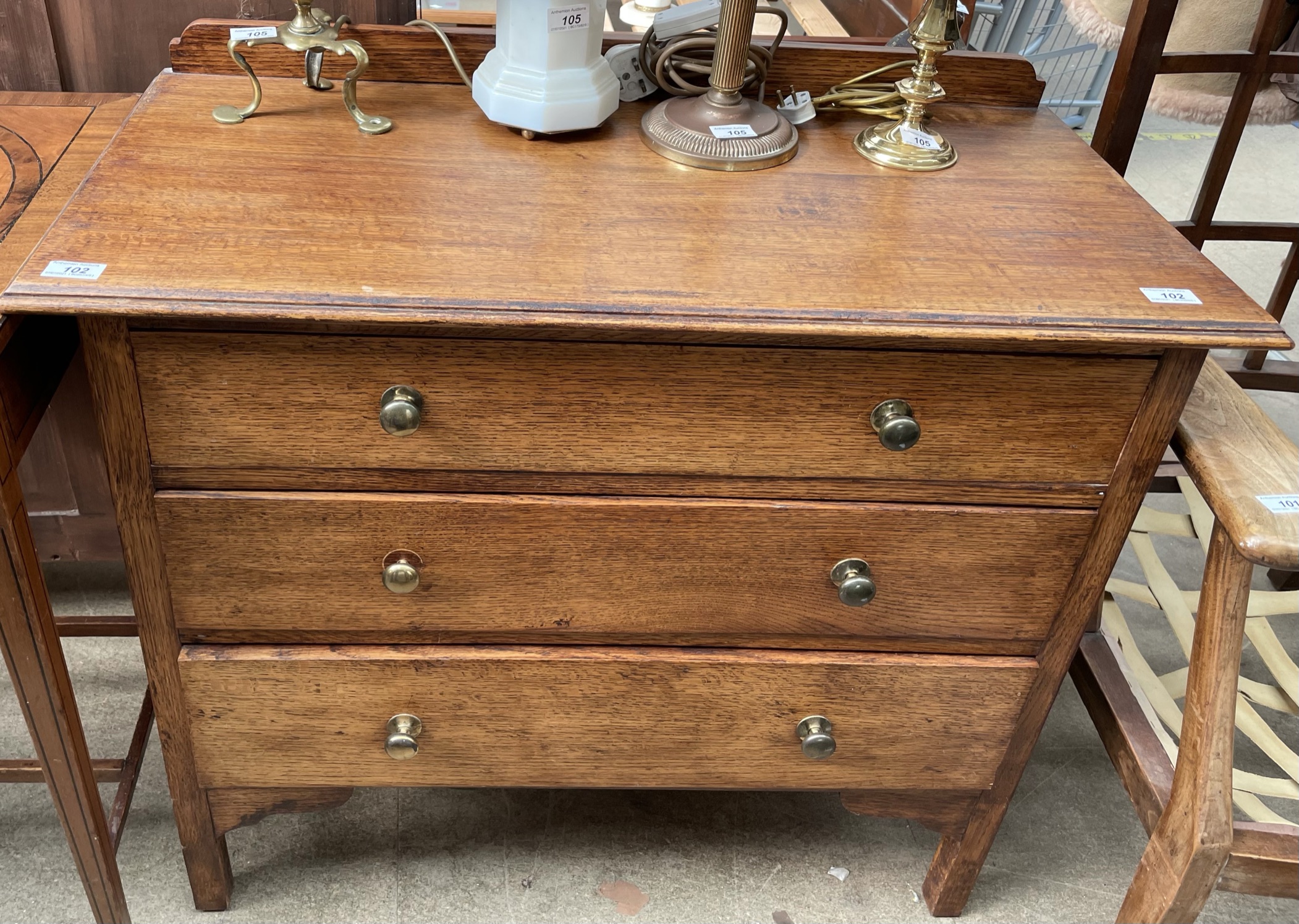 An early 20th century oak dressing chest with three drawers on square legs