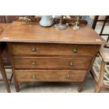 An early 20th century oak dressing chest with three drawers on square legs