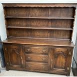 A 20th century oak dresser the rack with two shelves and a planked back,