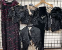 A collection of Victorian clothing including jackets, dress,