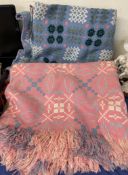 A pink welsh blanket with geometric decoration together with a blue welsh blanket