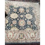 A blue ground rug with large flowerheads,