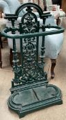 A cast iron umbrella stand, painted green,