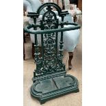 A cast iron umbrella stand, painted green,
