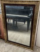 A gilt framed wall mirror of rectangular form